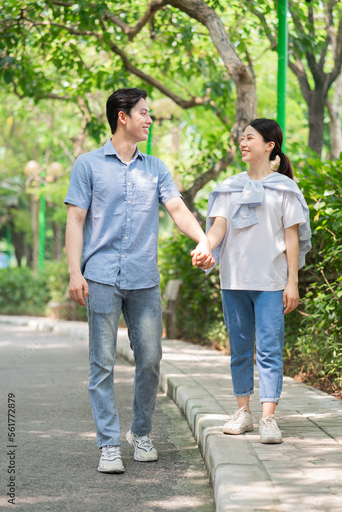 Image of young Asian couple outside