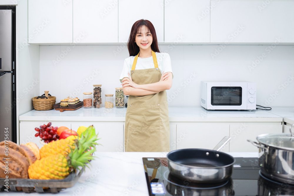 Image of young Asian woman in the kitchen