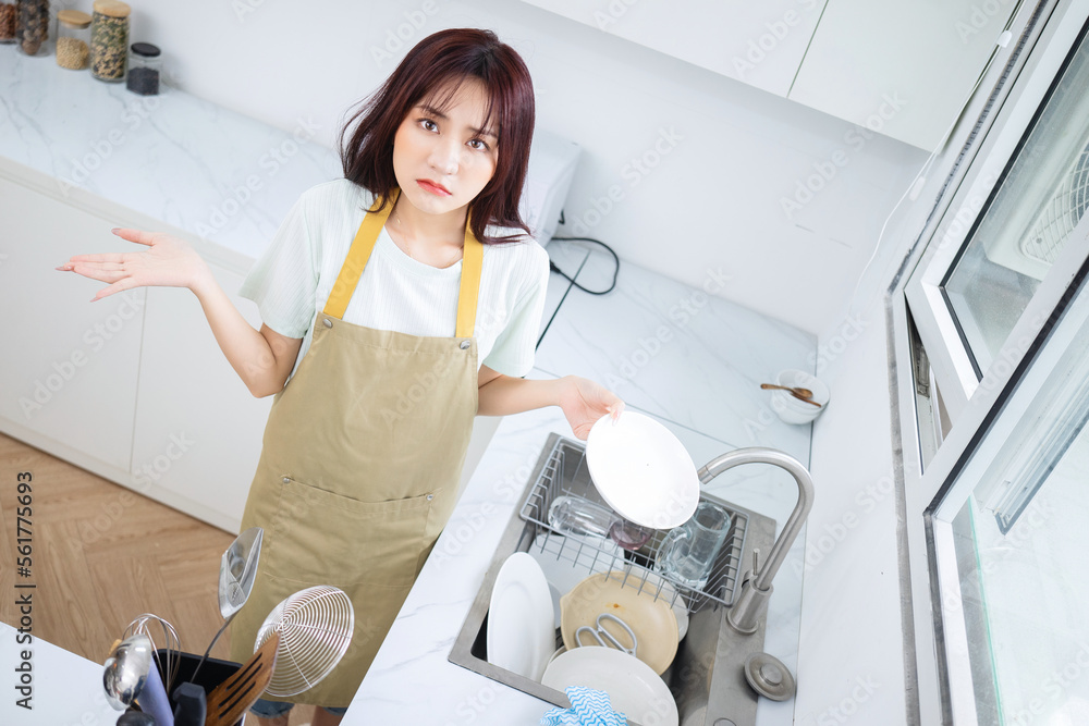 Image of young Asian woman in the kitchen