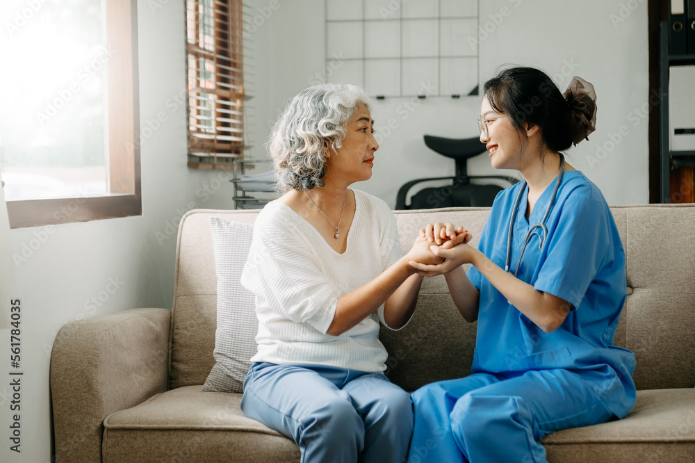 Asian female hands touching old female hand Helping hands take care of the elderly concept.