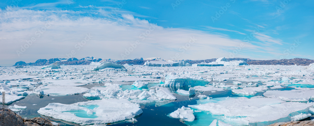 Melting icebergs by the coast of Greenland, on a beautiful summer day - Melting of a iceberg and pou