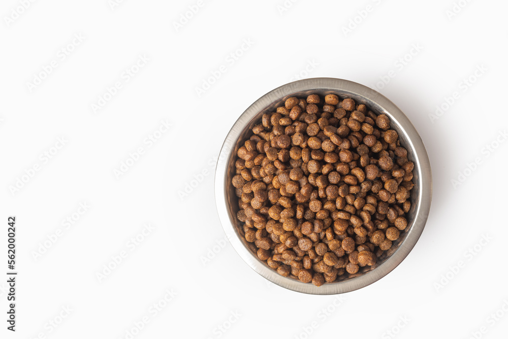 dry pet food in a metal bowl isolated on white background. Food for cats and dogs pattern. Pile of g