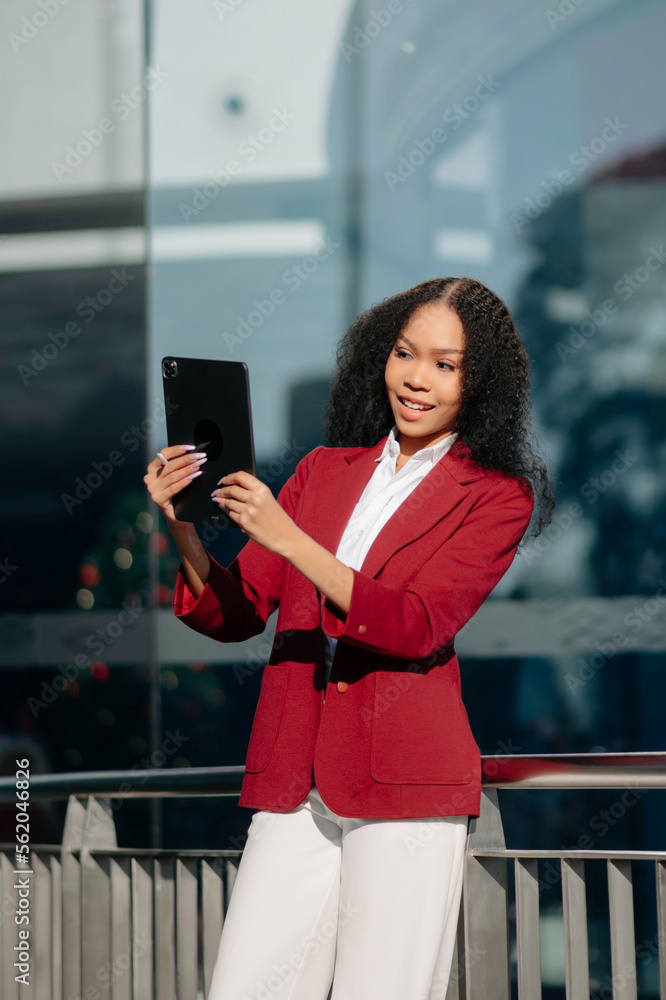  Working woman concept a female manager attending video conference and holding tablet, smatrphone an