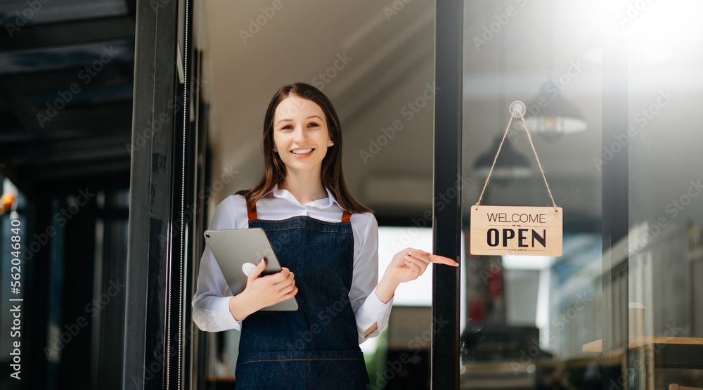 Startup successful small business owner sme woman stand with tablet and chart in cafe restaurant. wo