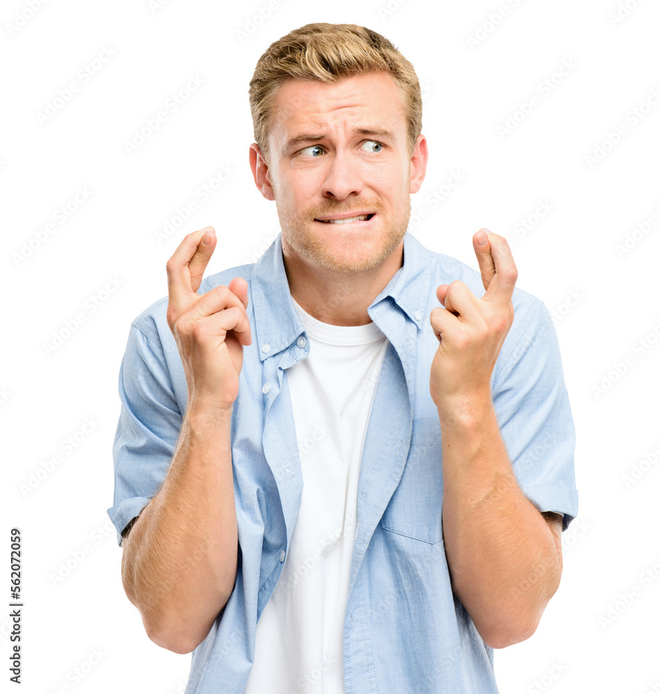 A handsome young man standing alone in the studio and feeling nervous while crossing his fingers iso