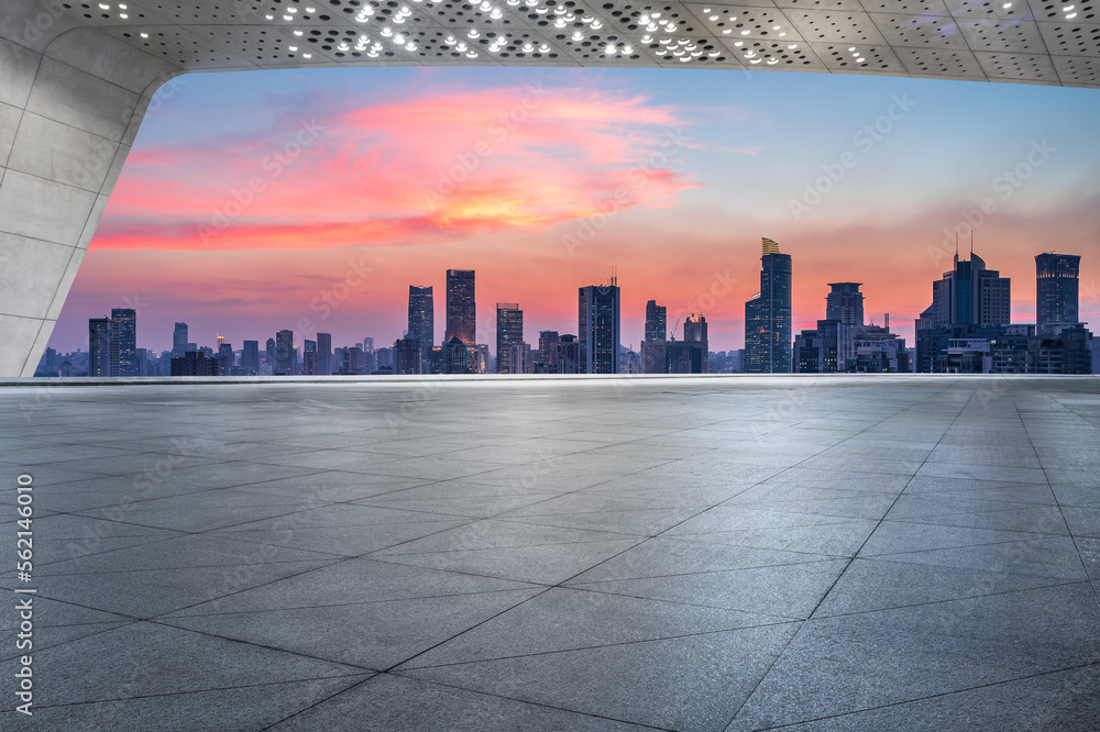 Empty floor and city skyline with modern buildings at sunset in Shanghai, China.