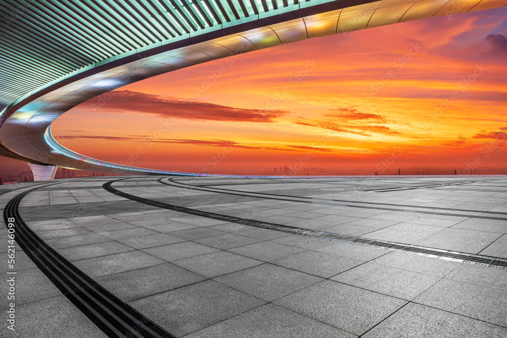 Empty square floor and bridge with city skyline at sunrise in Shanghai, China.