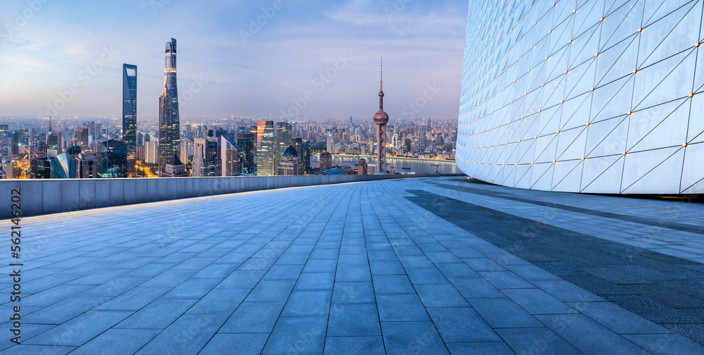 Empty square floor and city skyline with modern buildings at sunrise in Shanghai, China. High Angle 