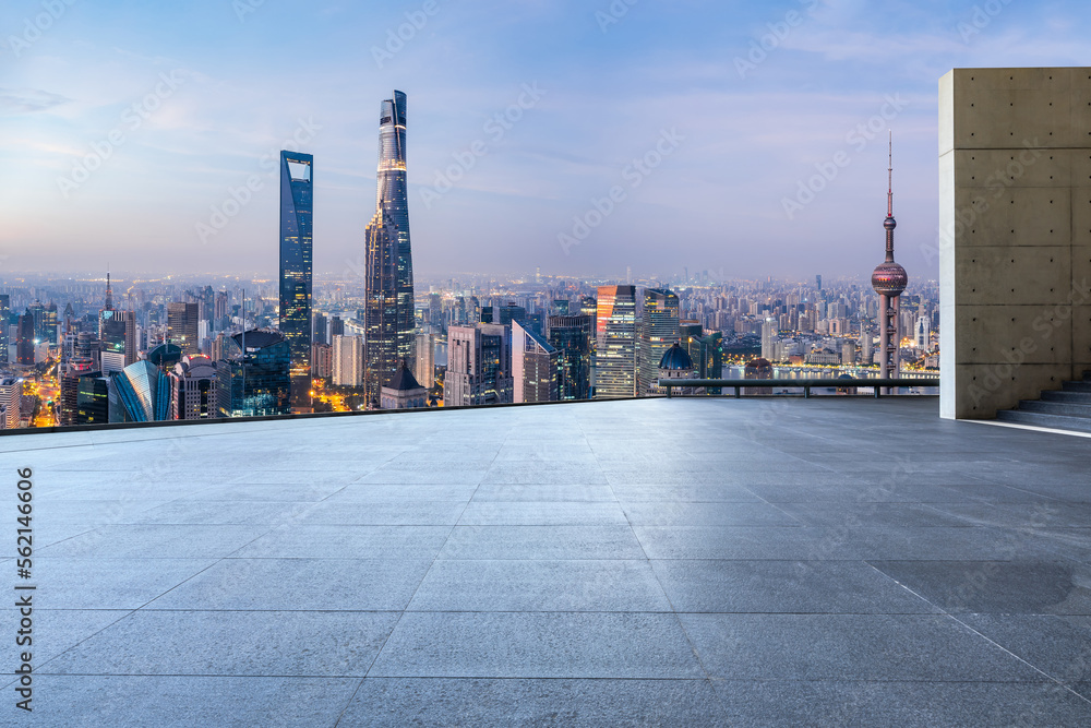 Empty square floor and city skyline with modern buildings at sunrise in Shanghai, China.