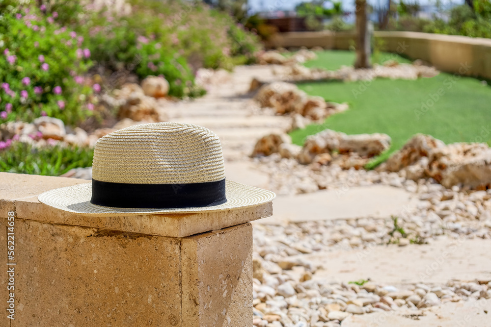 Summer hat on stone fence in park, closeup