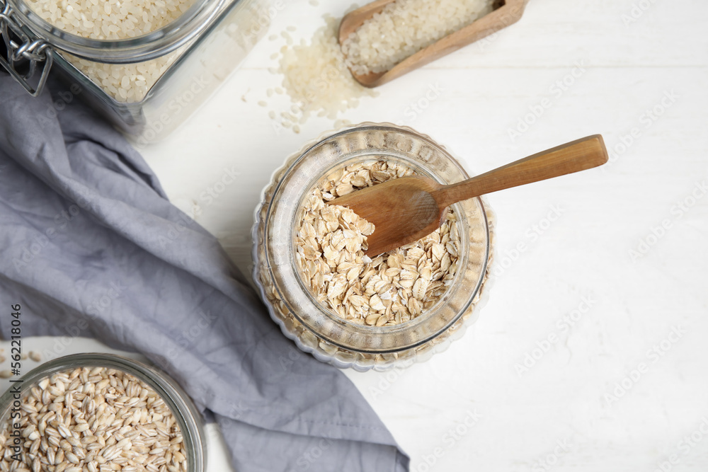 Jar with oatmeal on light wooden background