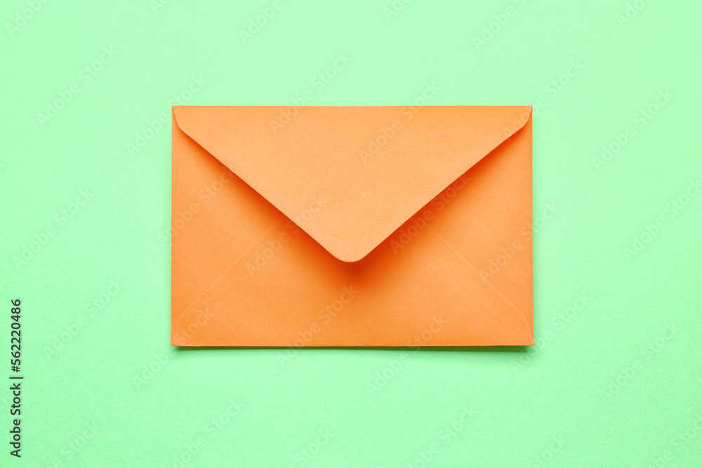 Orange paper envelope on color background