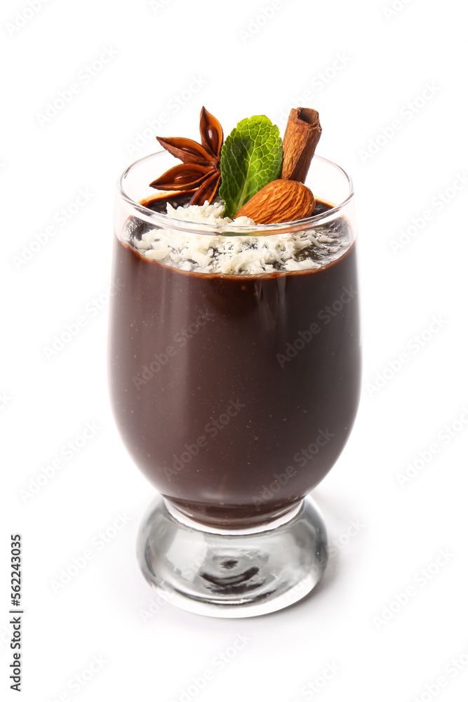 Glass of delicious chocolate pudding with almond, mint and cinnamon isolated on white background