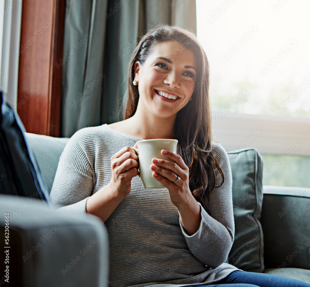 Coffee, thinking and relax with a woman in her home, sitting on a sofa in the living room feeling ha