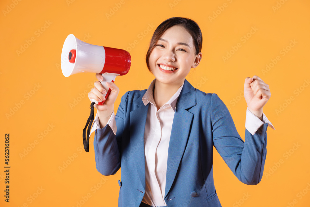 Photo of young Asian businesswoman holding megaphone on background