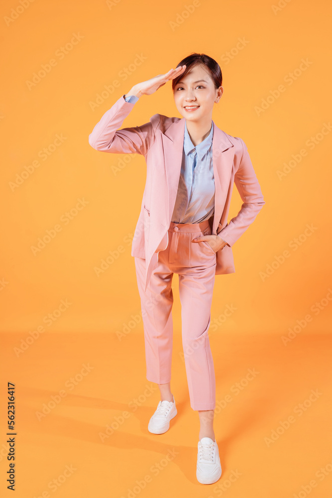 Young Asian businesswoman standing on background