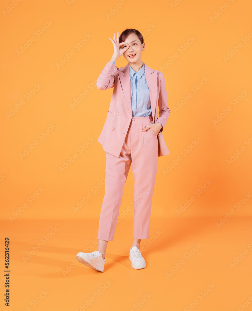 Young Asian businesswoman standing on background