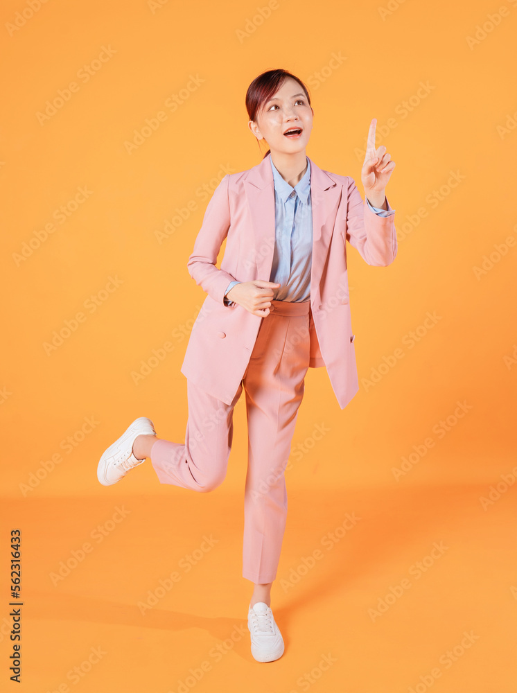 Young Asian businesswoman standing on background