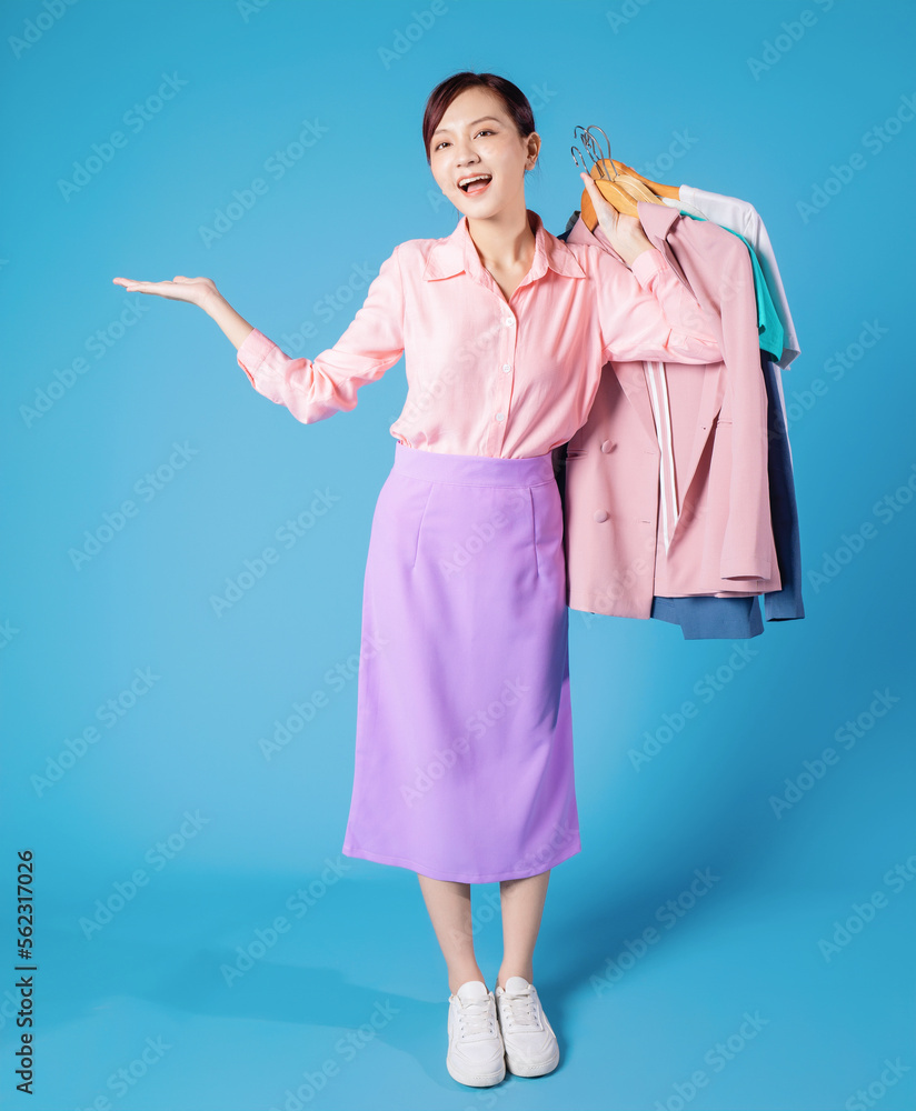 Image of young Asian businesswoman choosing clothes