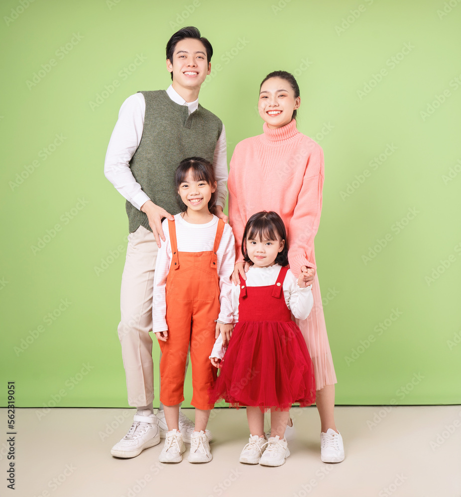 Image of young Asian family on background