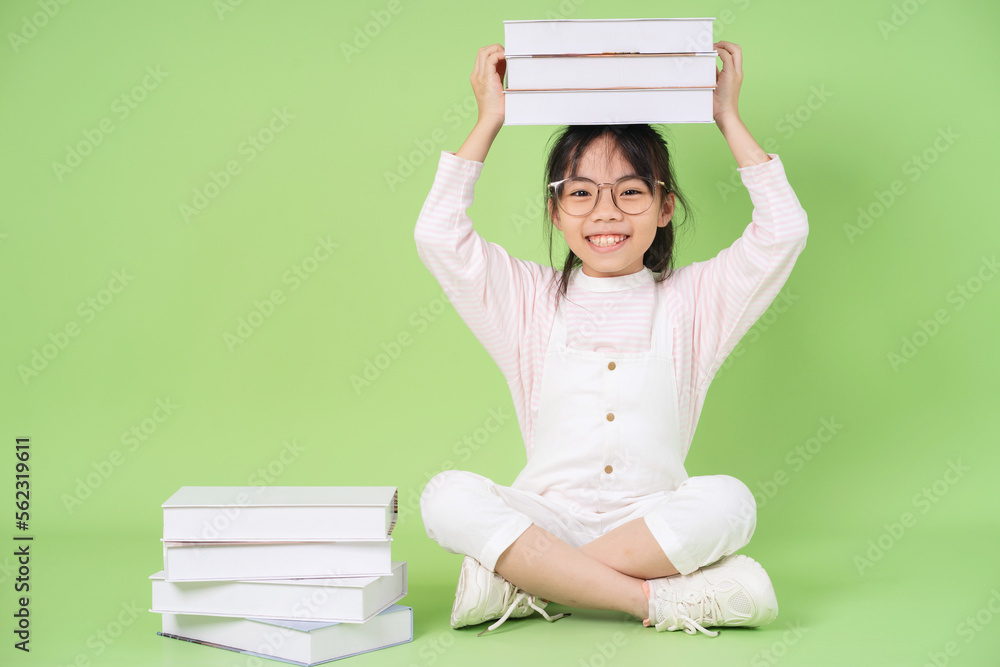 Portrait of Asian child on green background