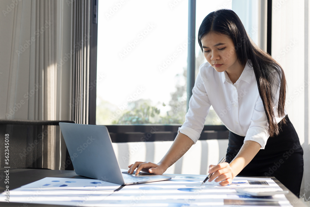 Female accountant working with financial figures on laptop.