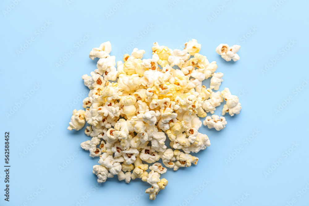 Heap of tasty popcorn on color background