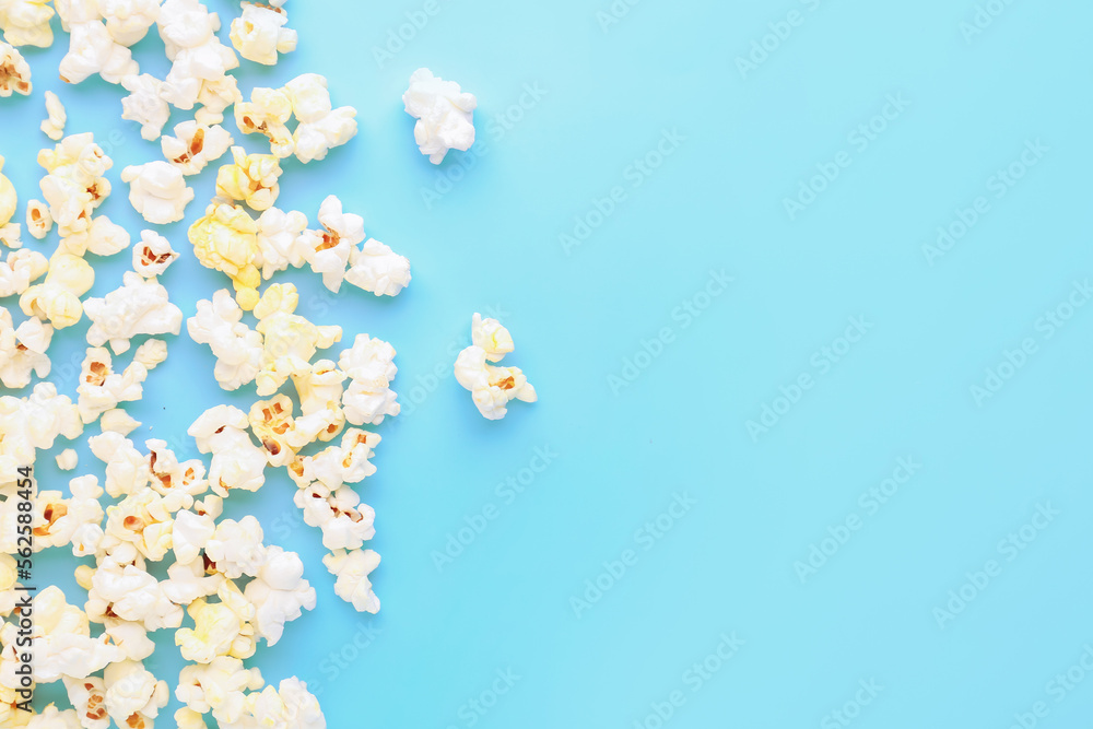 Scattered popcorn on color background