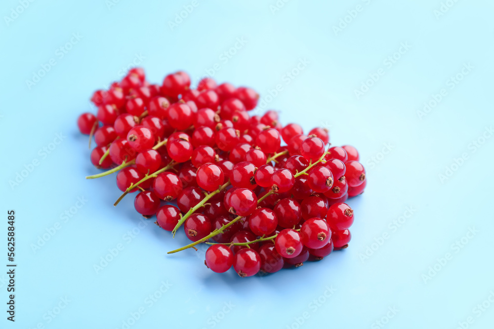 Heap of ripe red currant on color background