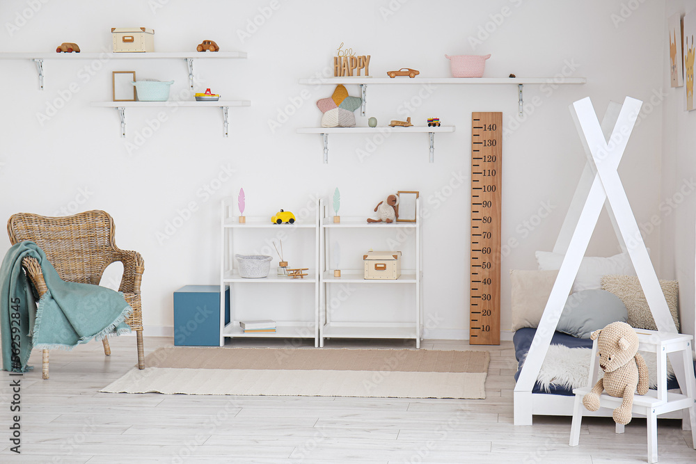 Stylish interior of childrens room with baby bed