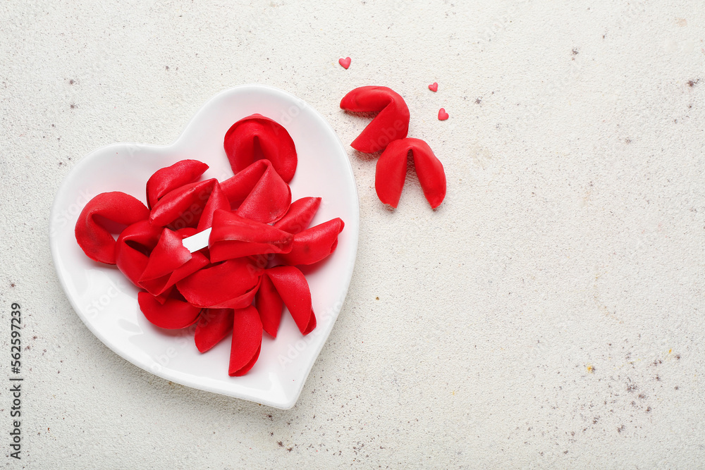 Plate with red fortune cookies on light background. Valentines Day celebration