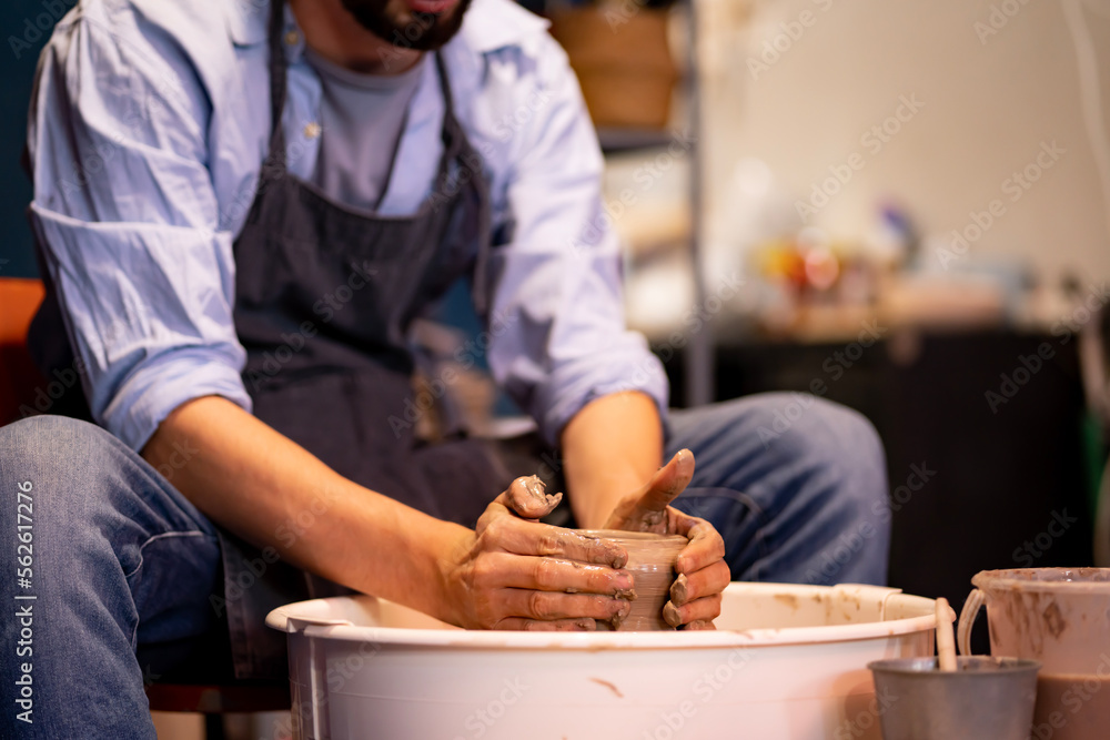 earthenware The art of sculpting clay with ceramics being molded by hand on a spinning machine. with