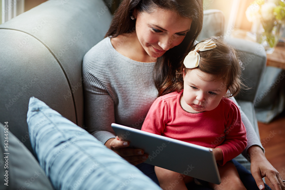 Mother, baby and tablet on sofa watching educational video online on streaming service in home. Love