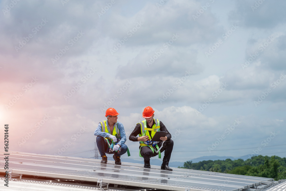 Solar panel technician with drill installing solar panels on roof factory,Sun energy,Solar panel.