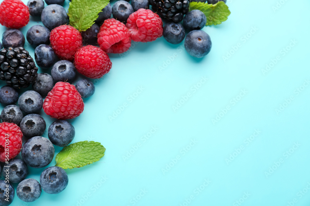 Composition with fresh berries and mint leaves on color background