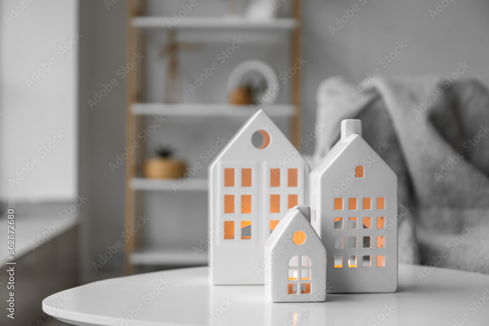 House candle holders on table in light living room, closeup