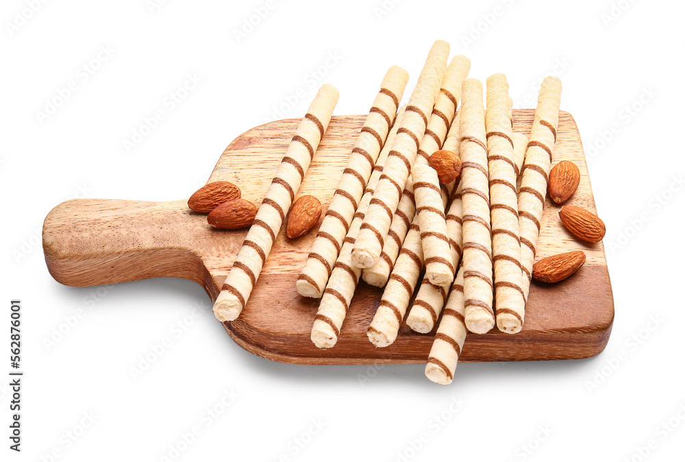 Cutting board with tasty wafer rolls and almonds isolated on white background