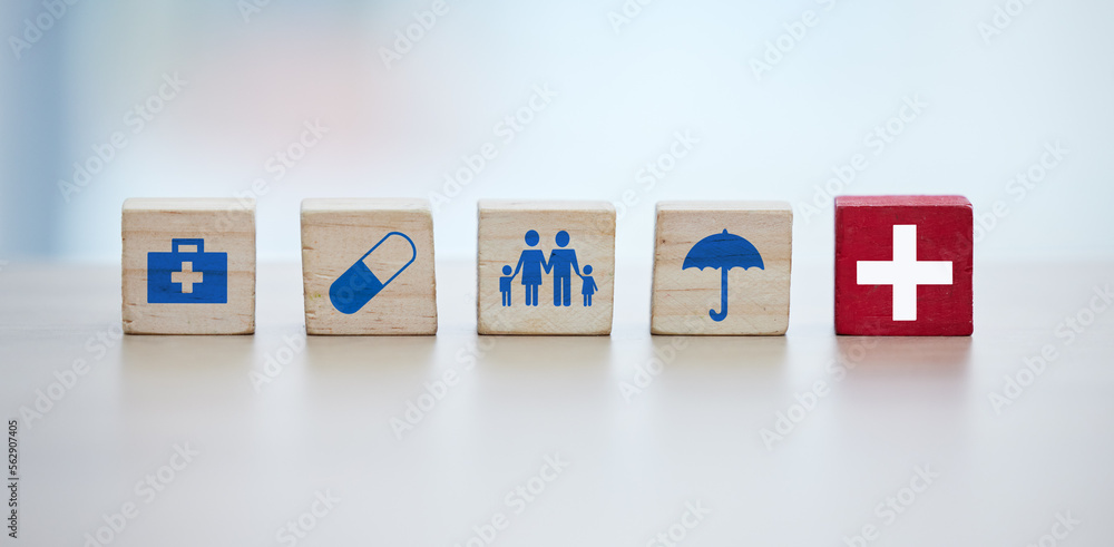 Healthcare, insurance and wooden blocks in studio on an empty gray background for safety or security