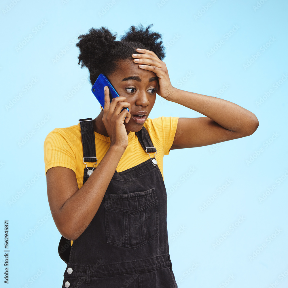 Shocked, surprised and black woman on a phone call for news isolated on a blue background in studio.