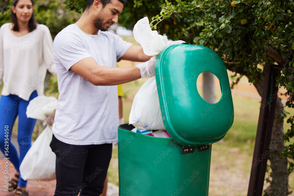 Volunteer cleaning, garbage bin and man throw trash, pollution or waste product for environment supp