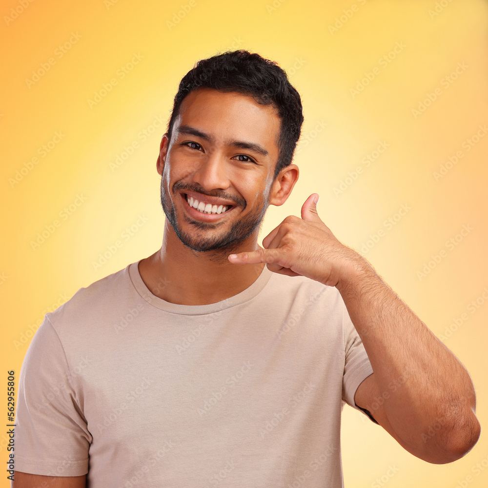 Portrait, call me hands and man in studio isolated on a yellow background. Face, fashion and happy m