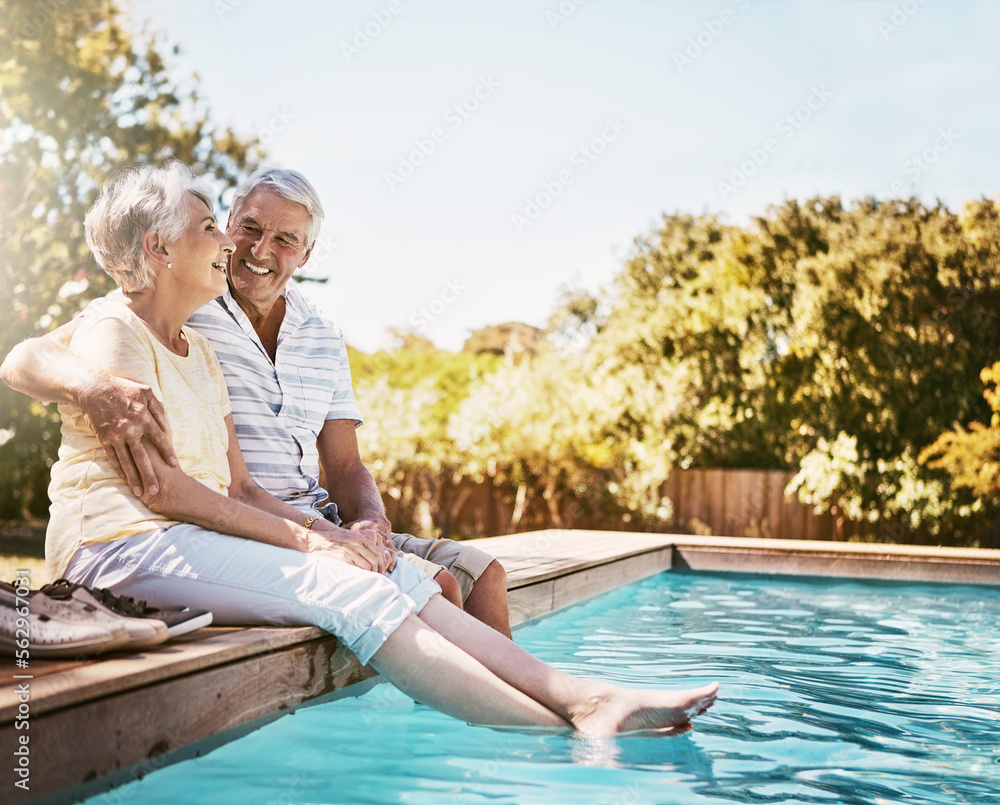 Senior couple, hug and smile by swimming pool for relax, love or quality bonding time together on su