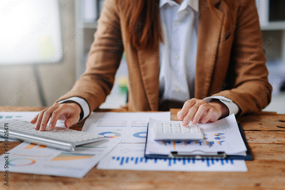 Close up of businesswoman or accountant hand typing laptop working to calculate on desk about cost a