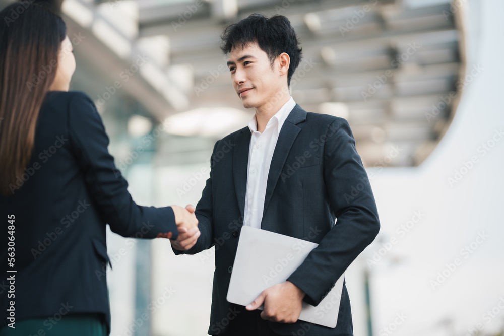 Businessmen making handshake in the city business etiquette, congratulation, merger and acquisition 