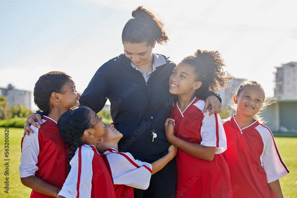 Girl football team, coach celebration and hug for success, teamwork and group diversity on grass pit