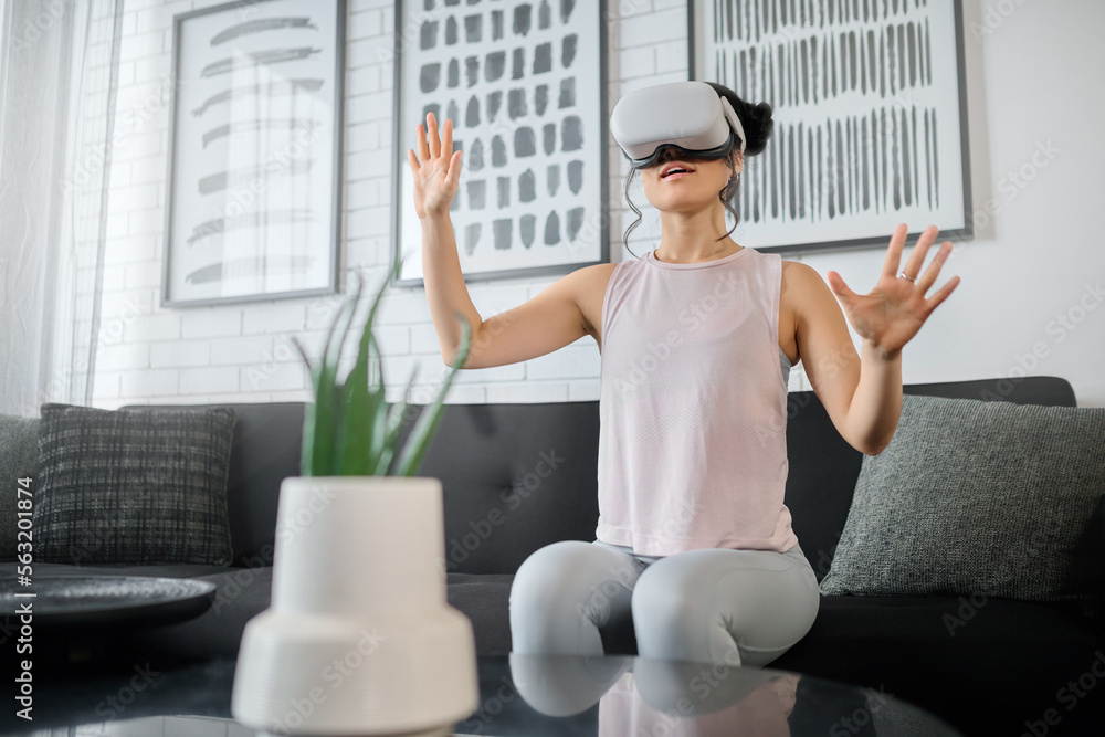 VR, metaverse and technology with a woman in the living room of her home using a headset to access a