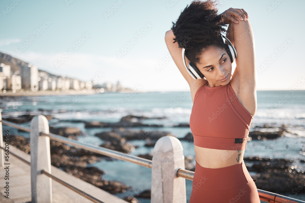 Beach, fitness and woman doing a stretching exercise before running or training for a race or marath