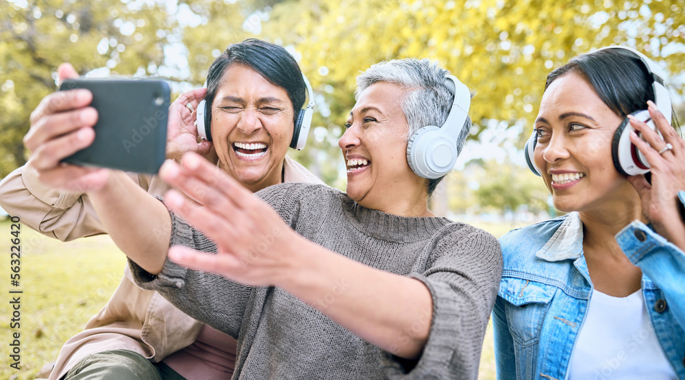 Senior woman, friends and phone laughing with headphones listening to music or watching comedy movie