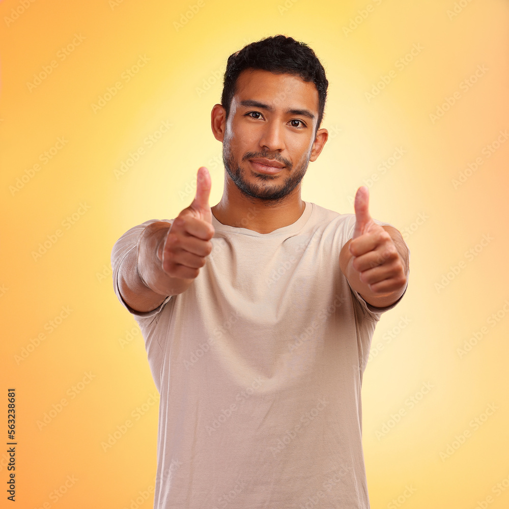 Portrait, hands and man with thumbs up in studio isolated on a yellow background. Face, fashion and 