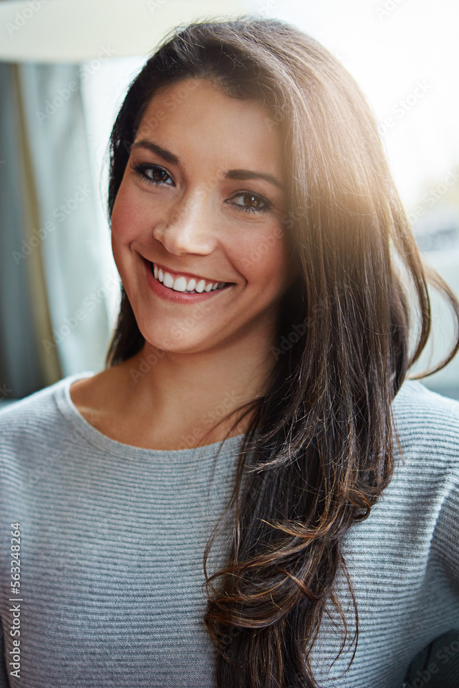 Beautiful woman, portrait smile and brunette relaxing at home with long hair in casual wear and posi